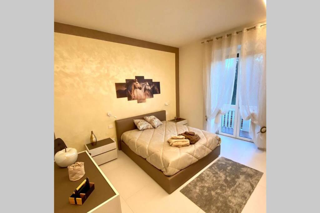 a bedroom with a bed and a large window at Nuova Residenza Porta Nuova winehorse Verona in Verona