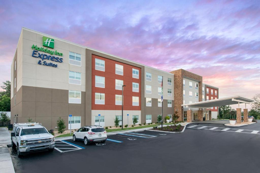 a rendering of a hotel with cars parked in a parking lot at Holiday Inn Express Melbourne West by IHG in Melbourne