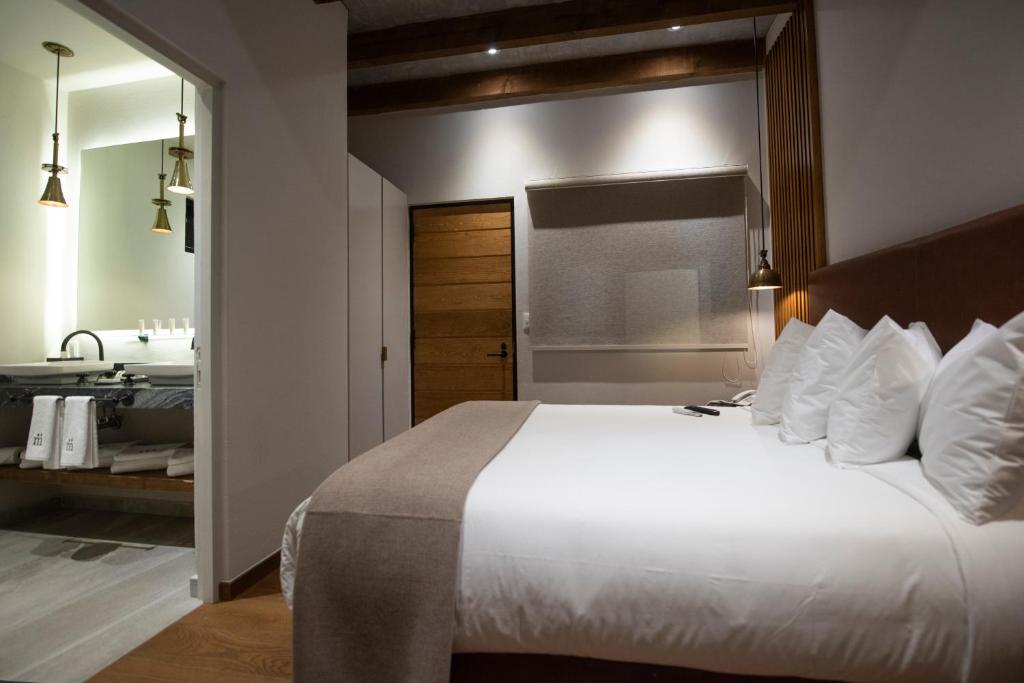 Postel nebo postele na pokoji v ubytování Hotel Madi