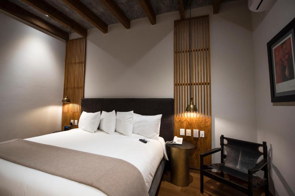 Postel nebo postele na pokoji v ubytování Hotel Madi