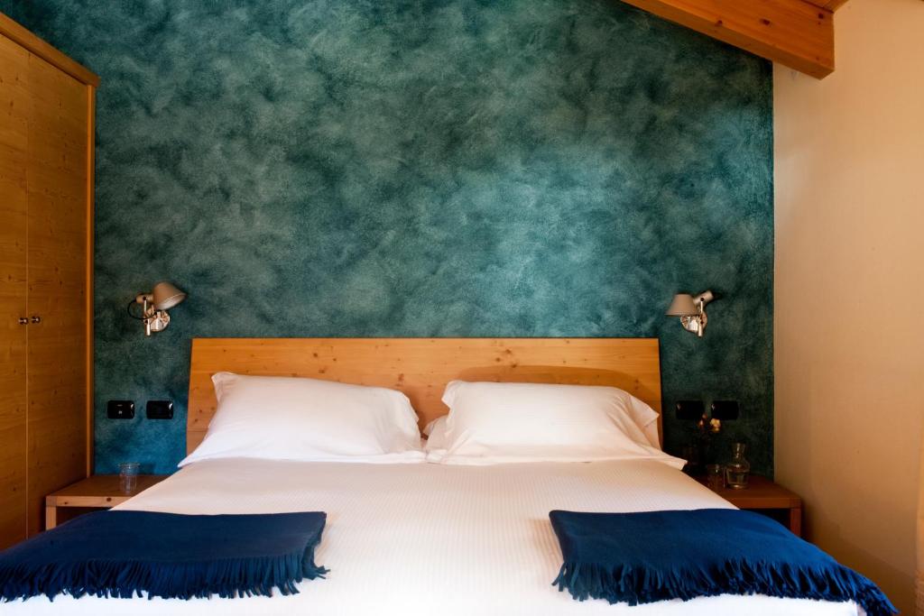 Postel nebo postele na pokoji v ubytování Hotel Meublè Sertorelli Reit