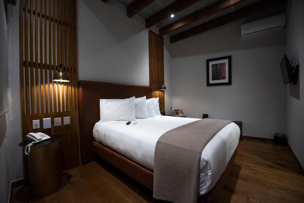 Postel nebo postele na pokoji v ubytování Hotel Madi