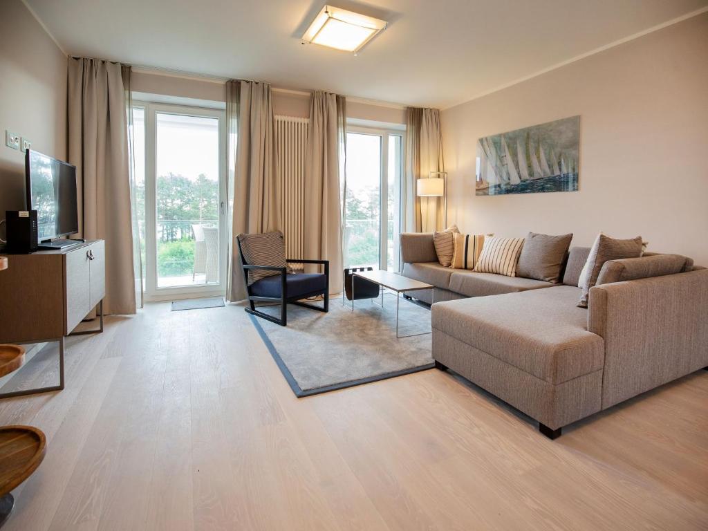 a living room with a couch and a tv at Dünenresidenz Prora - Ferienwohnung mit Meerblick, 2 Schlafzimmern und Balkon NP-311 in Binz