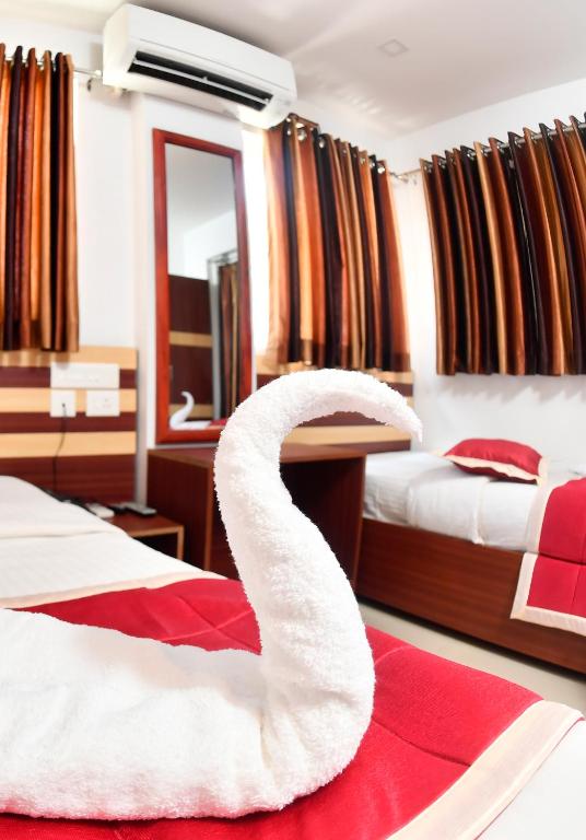 Postel nebo postele na pokoji v ubytování Puthens Capitol Inn