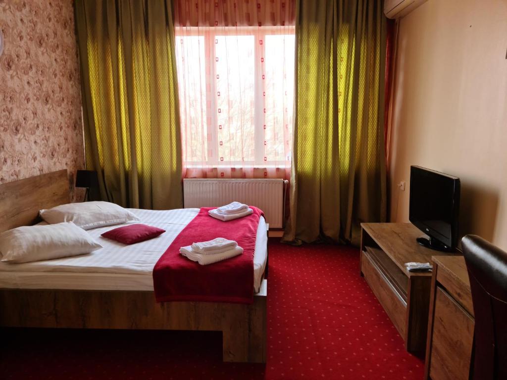 Postel nebo postele na pokoji v ubytování Hotel Olimp