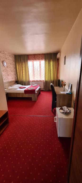 Postel nebo postele na pokoji v ubytování Hotel Olimp