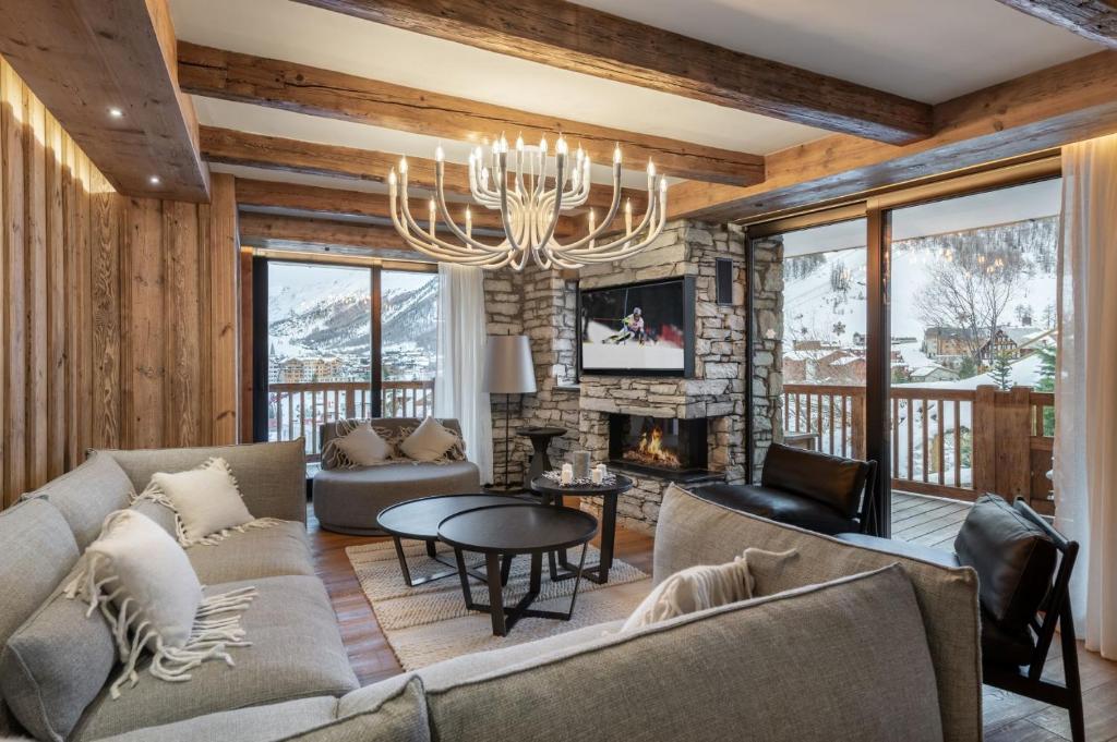 a living room with a couch and a fireplace at Penthouse Best View - Les Chalets COVAREL in Val-d'Isère