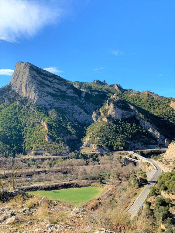 a view of a mountain with a road on it at Camping Oliana in Oliana