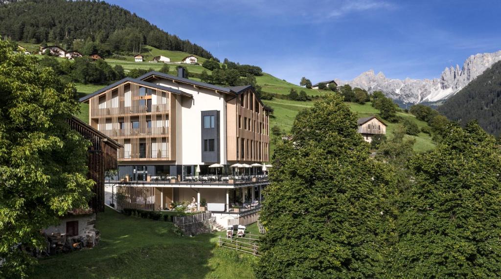 a building on top of a hill with trees at Alpinhotel Vajolet - Adults only in Tires