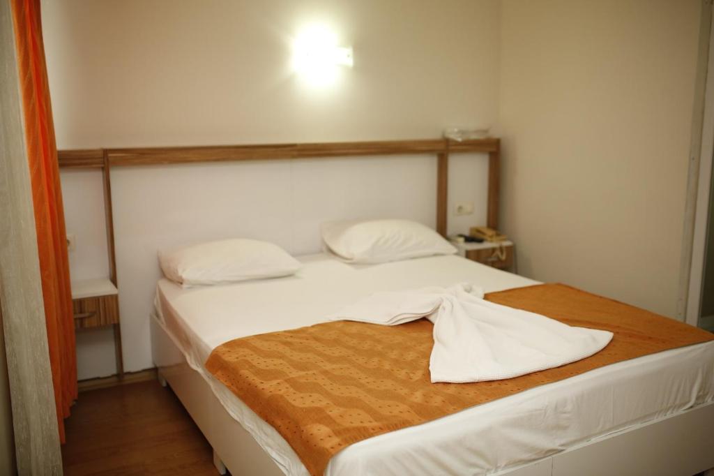 Postel nebo postele na pokoji v ubytování Özhan Hotel
