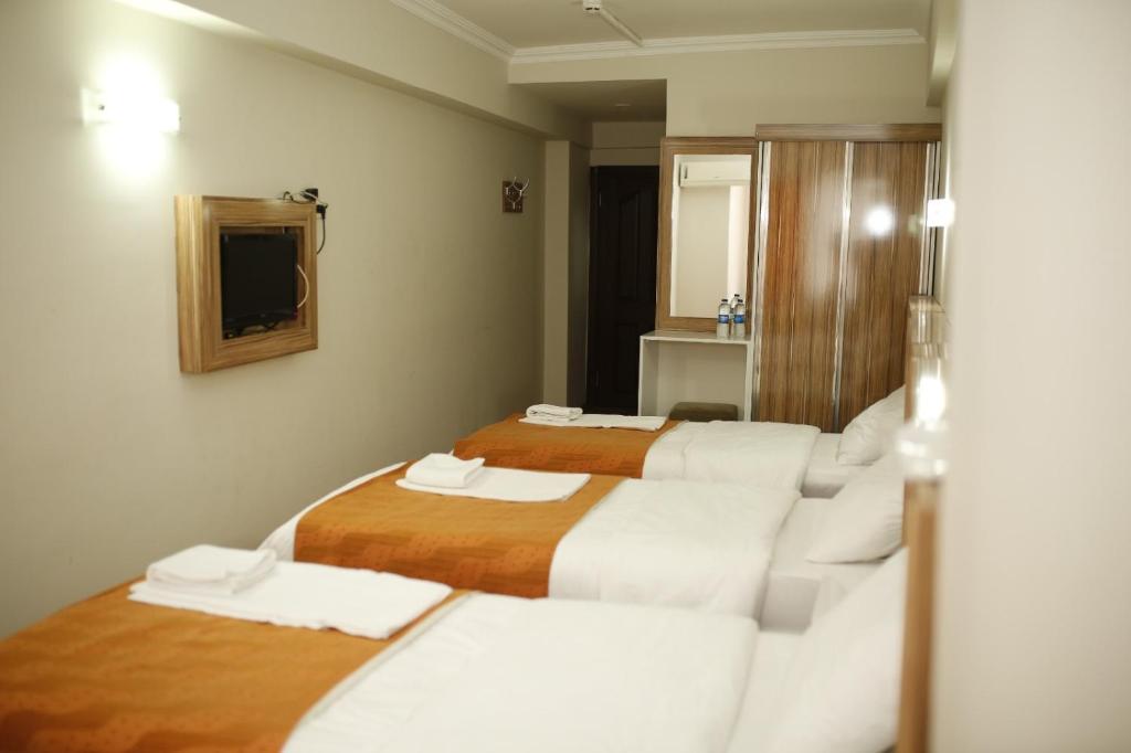 Postel nebo postele na pokoji v ubytování Özhan Hotel