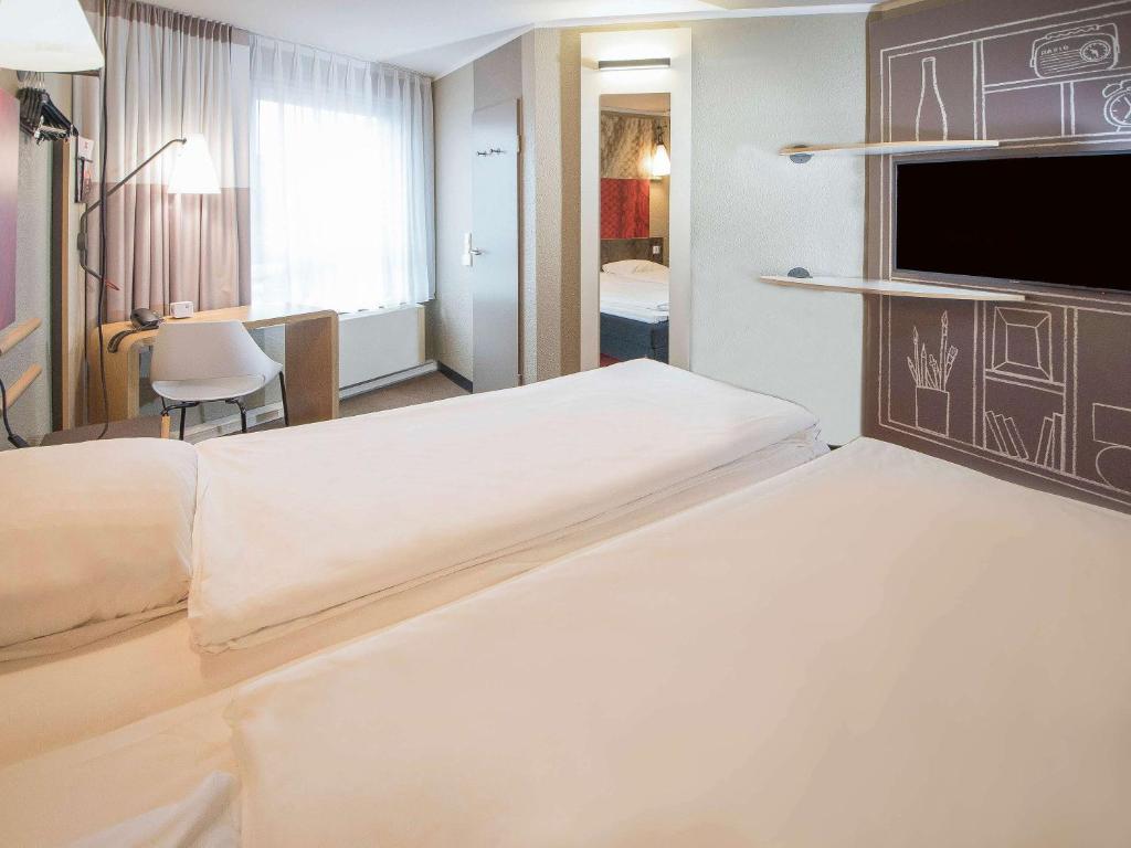 Postel nebo postele na pokoji v ubytování ibis Heidelberg Hauptbahnhof