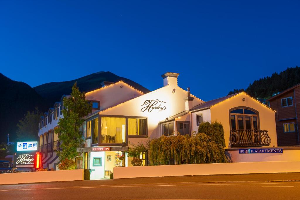 a building on the side of a street at night at Hurley's of Queenstown in Queenstown