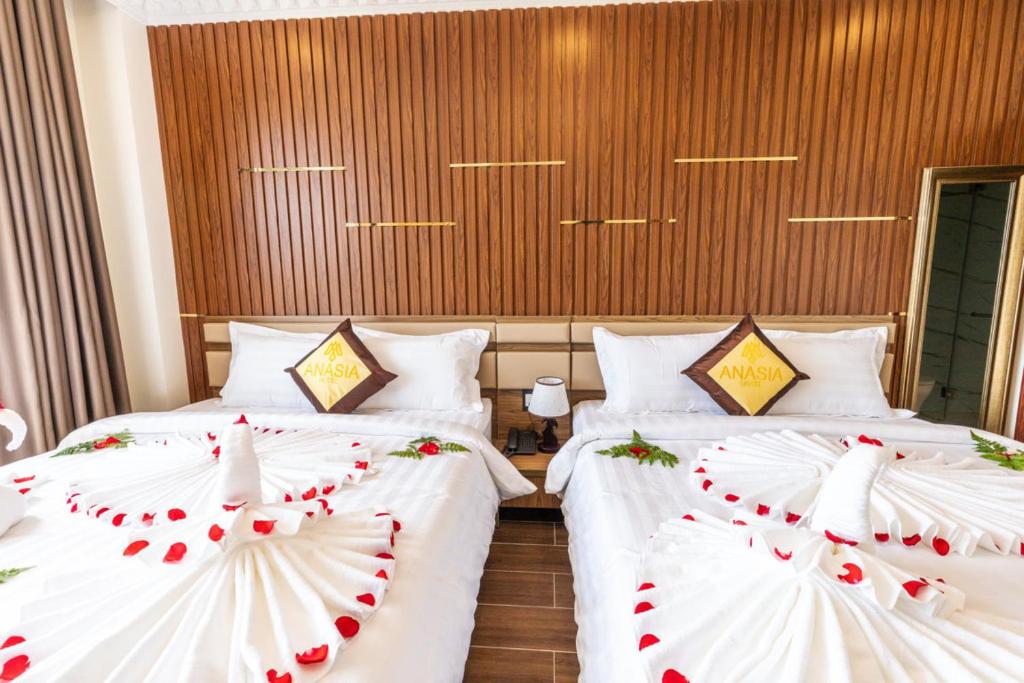 two beds in a hotel room with hearts on them at Anasia Hotel in Da Lat