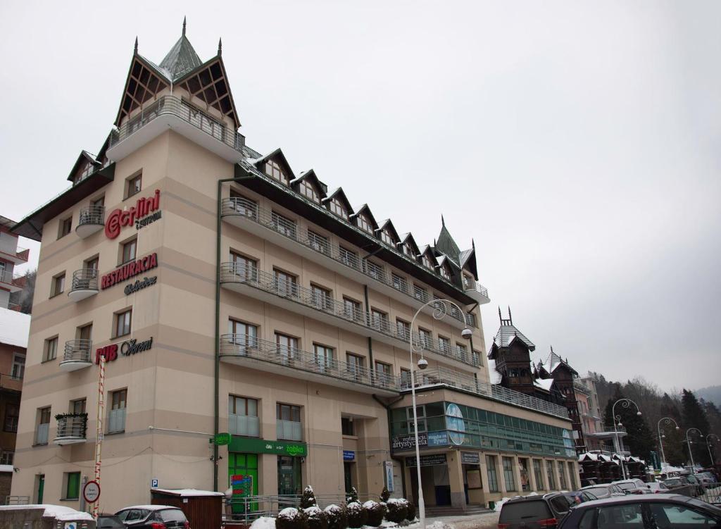 a large building with a pointed roof at Apartament dwuosobowy203, 310,410, in Krynica Zdrój