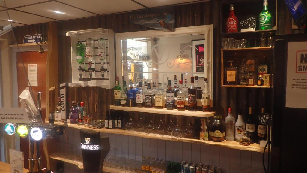 a bar with a lot of bottles of alcohol at The Victoria guest house in Mablethorpe