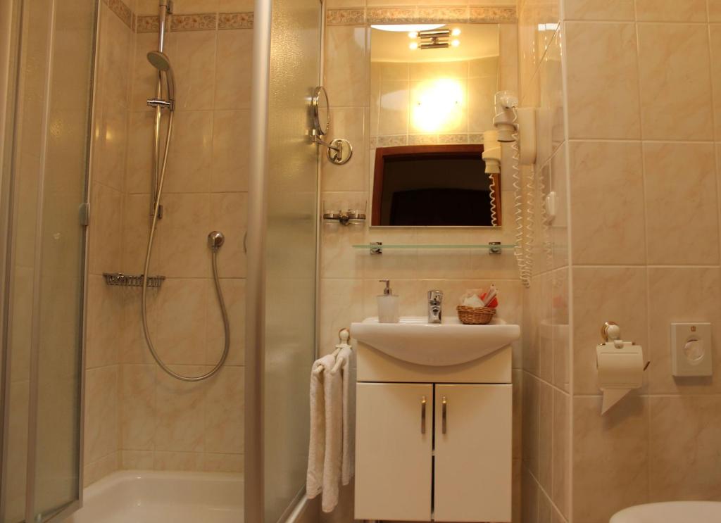 y baño con ducha, lavabo y aseo. en Stadthotel Augsburg, en Augsburg