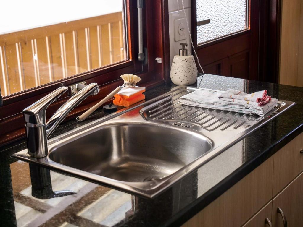 a stainless steel kitchen sink in a kitchen at Camping Jungfrau in Lauterbrunnen