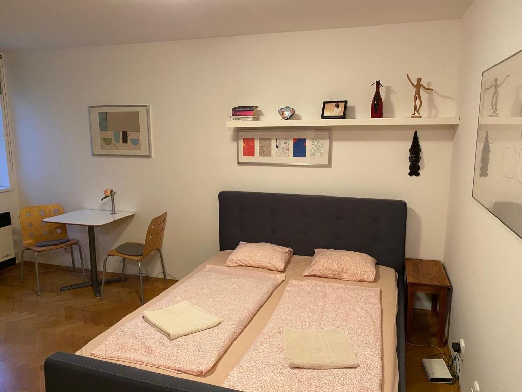 a bedroom with a bed and a table with chairs at Apartment Florenc in Prague