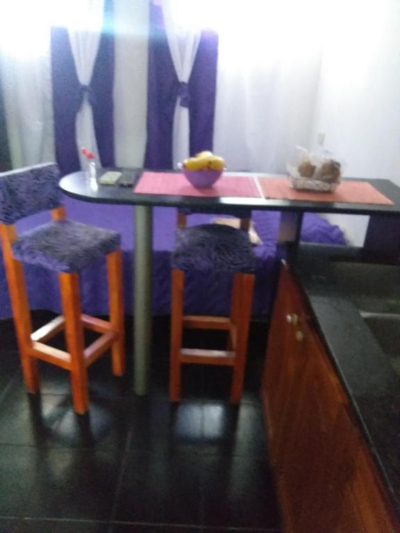 a table with two chairs and a bowl of bananas on it at CHE LOLITA HOUSE in Buenos Aires