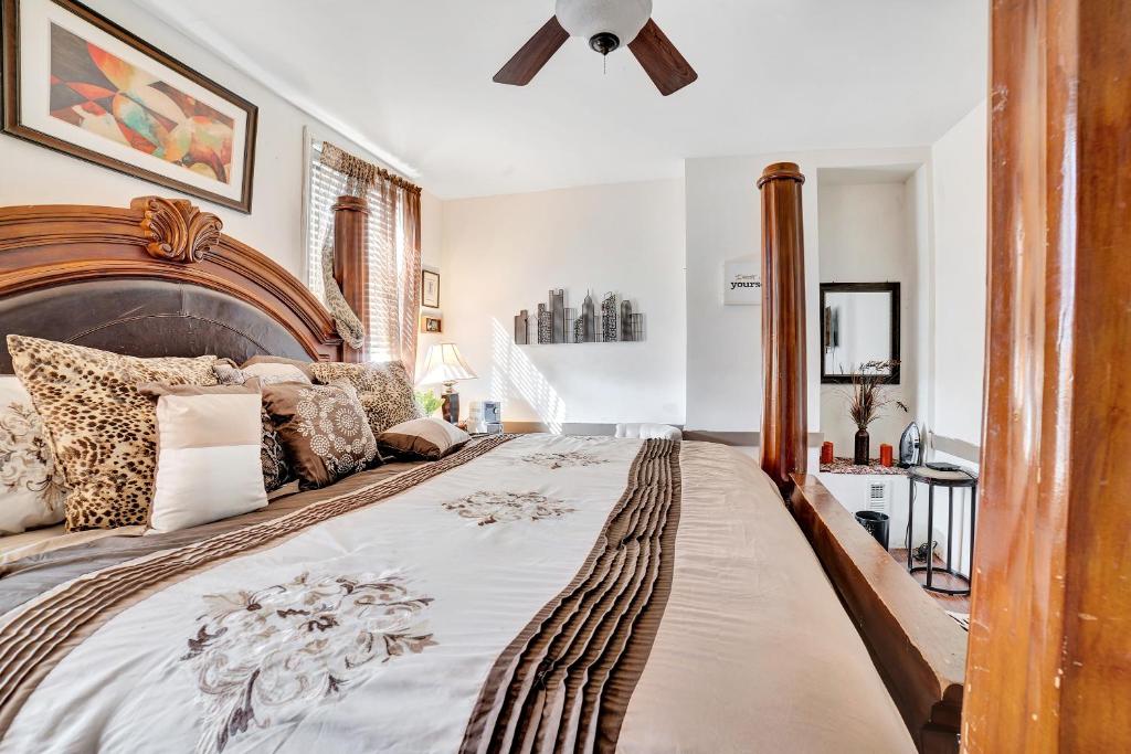 um quarto com uma cama grande e uma cabeceira em madeira em Delightful Empowerment Palace em Filadélfia