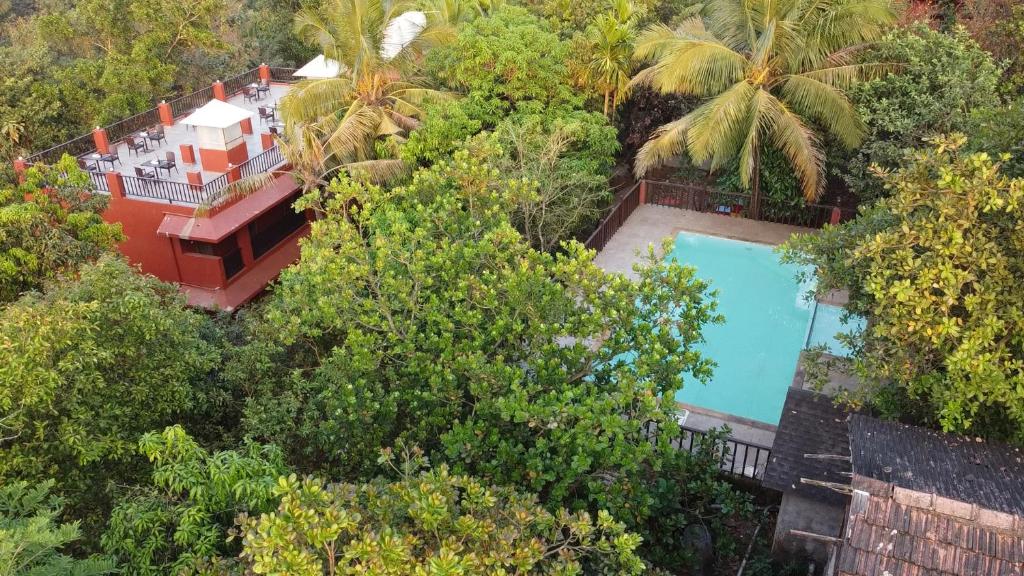 an aerial view of a house with a swimming pool at Keys Lite by Lemon Tree Hotels Sylvan, Dapoli in Dapoli
