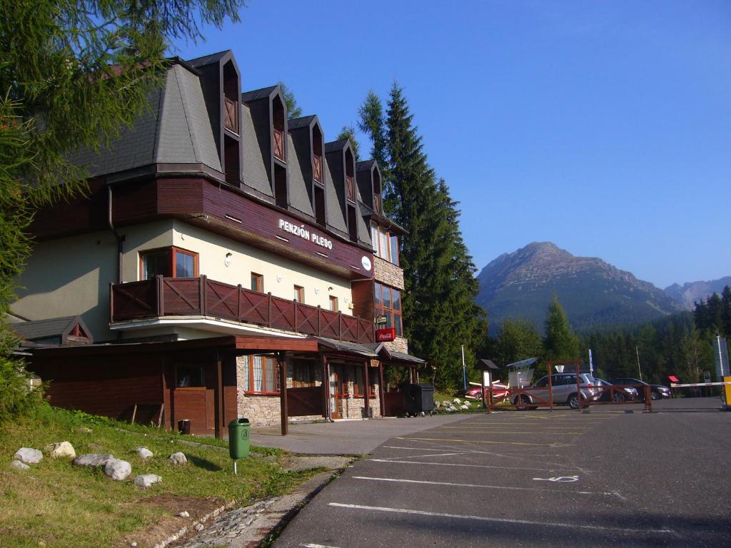 a large building on the side of a street at Penzión Pleso in Štrbské Pleso
