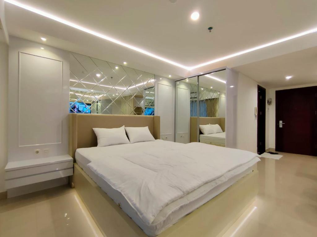 Кровать или кровати в номере Platinum 1010 Studio Tera Apartemen Bandung City View