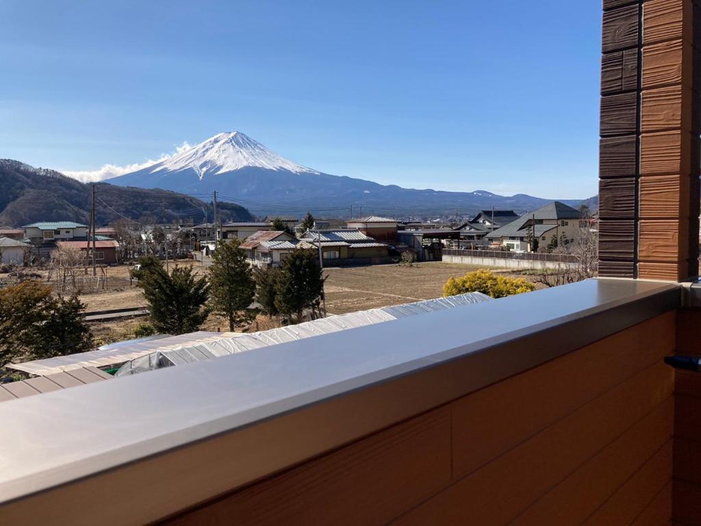 a view of a snow covered mountain from a house at Furaku-Cat in Fujikawaguchiko