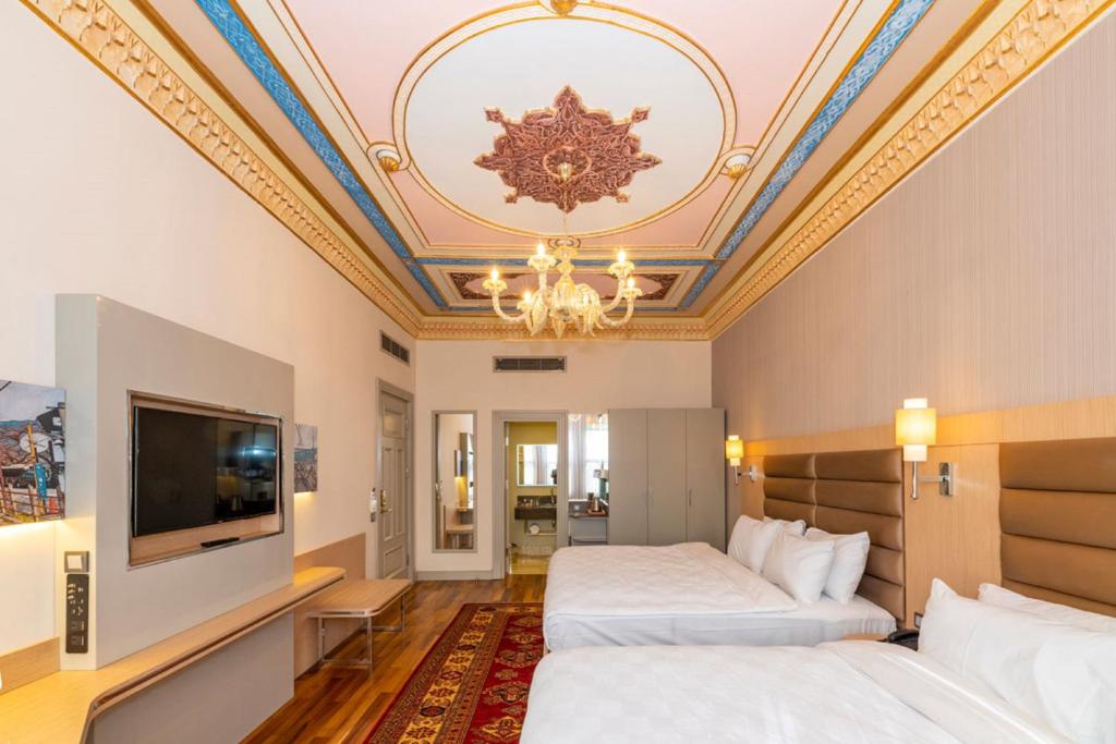 a hotel room with two beds and a ceiling at Blue Gilroy Hotel in Istanbul