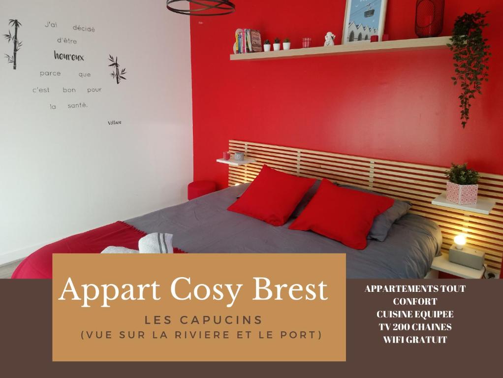 a red bedroom with a bed with red pillows at Appart Cosy Brest Les Capucins in Brest