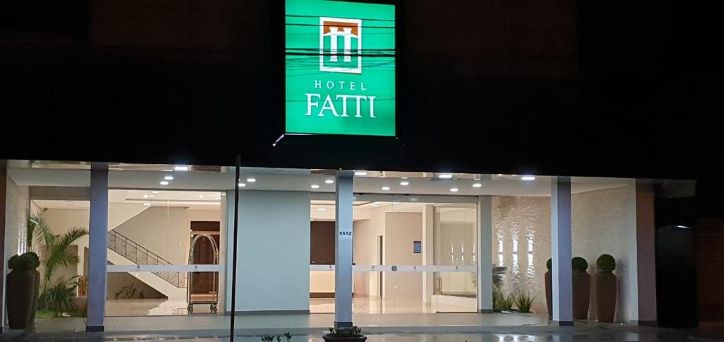 a sign that reads hotel faith in front of a building at Hotel Fatti in Maringá