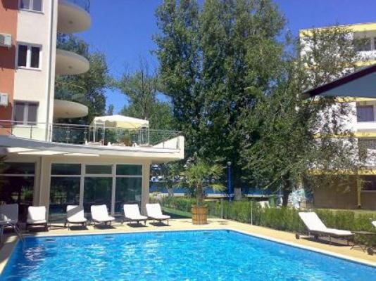 a swimming pool with lounge chairs and a building at Ale Summer Suite in Mamaia