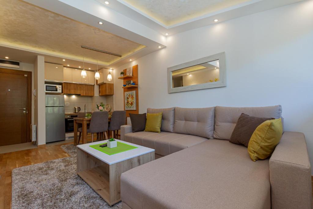 a living room with a couch and a table at Apartman & SPA Djuric Zlatibor in Zlatibor
