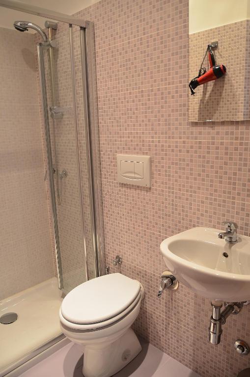 a bathroom with a toilet and a sink and a shower at Hostel Castello Maggiore in Rome