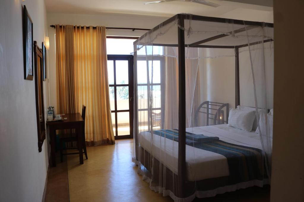 Postel nebo postele na pokoji v ubytování Esprit d'Ici Hotel