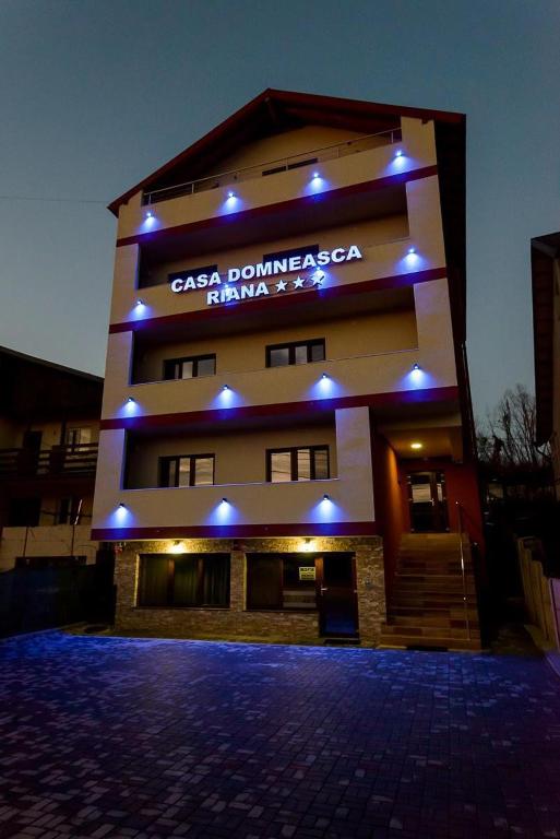 a building with a sign on the side of it at Casa Domneasca Riana in Piteşti
