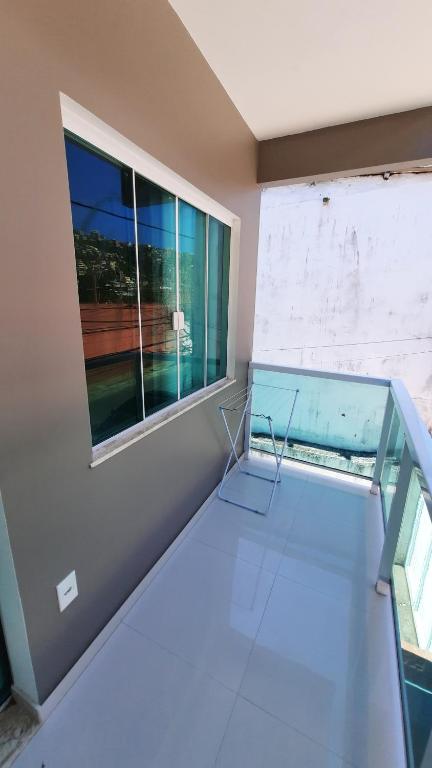 a glass table in a room with a window at Seasun Suítes in Arraial do Cabo