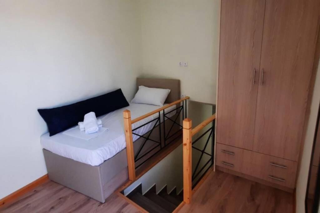 a small room with a bunk bed and a cabinet at Manto Apartments Lefkada in Évyiros