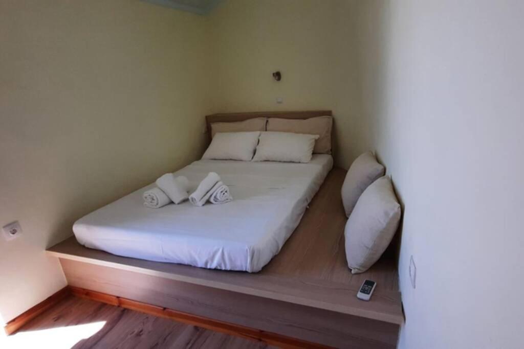 a bed with two pillows on it in a room at Manto Apartments Lefkada in Évyiros