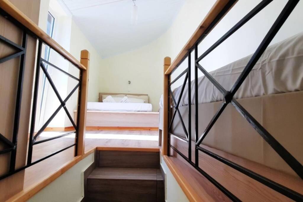 a staircase leading to a bedroom with a bed at Manto Apartments Lefkada in Évyiros