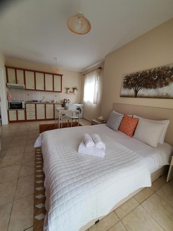 a bedroom with a large bed with towels on it at Stergios_Apartments 06 in Kozani