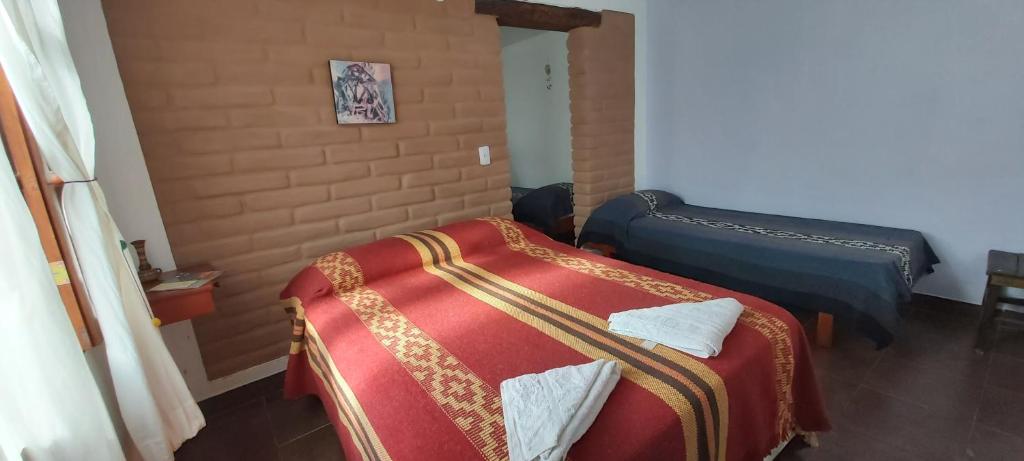 Una cama o camas en una habitación de Las Pircas alquiler temporario habitaciones y cabañas