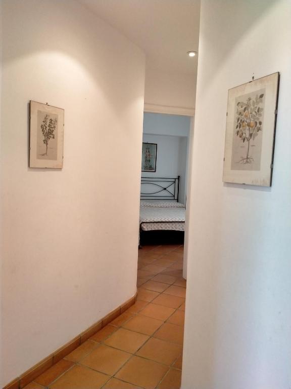 a hallway with two pictures on the wall and a bed at Villa Rossi in Polignano a Mare