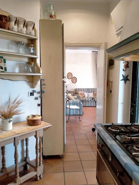 a kitchen with an open door to a living room at Villa Rossi in Polignano a Mare