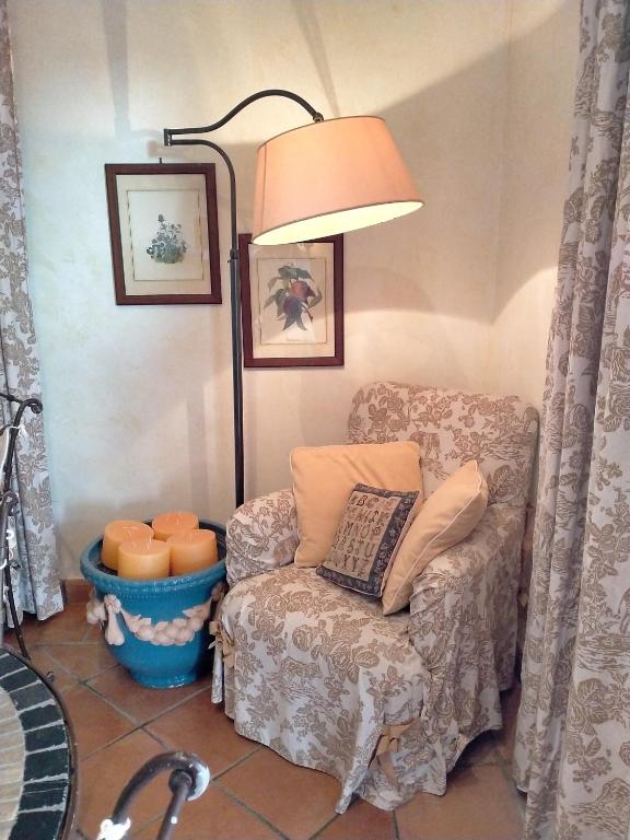 a living room with a chair and a lamp at Villa Rossi in Polignano a Mare