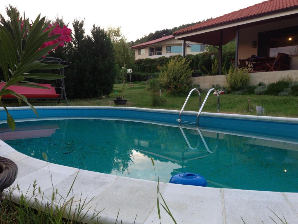 a swimming pool in the yard of a house at Summer Villa Boutique Varna in Varna City