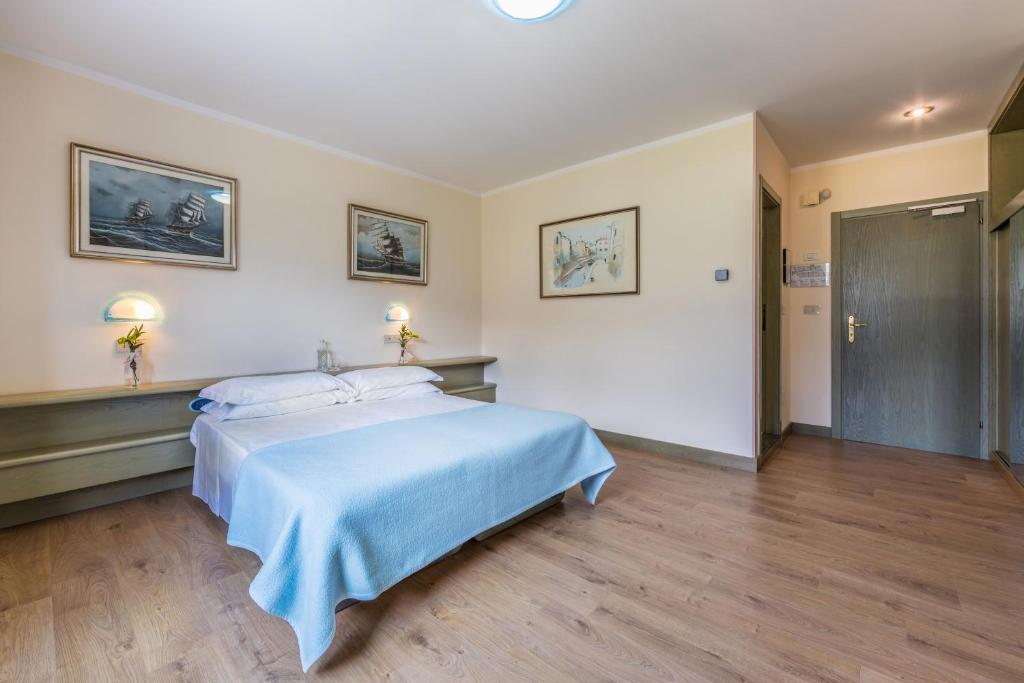 Postel nebo postele na pokoji v ubytování Aviano Palace Hotel