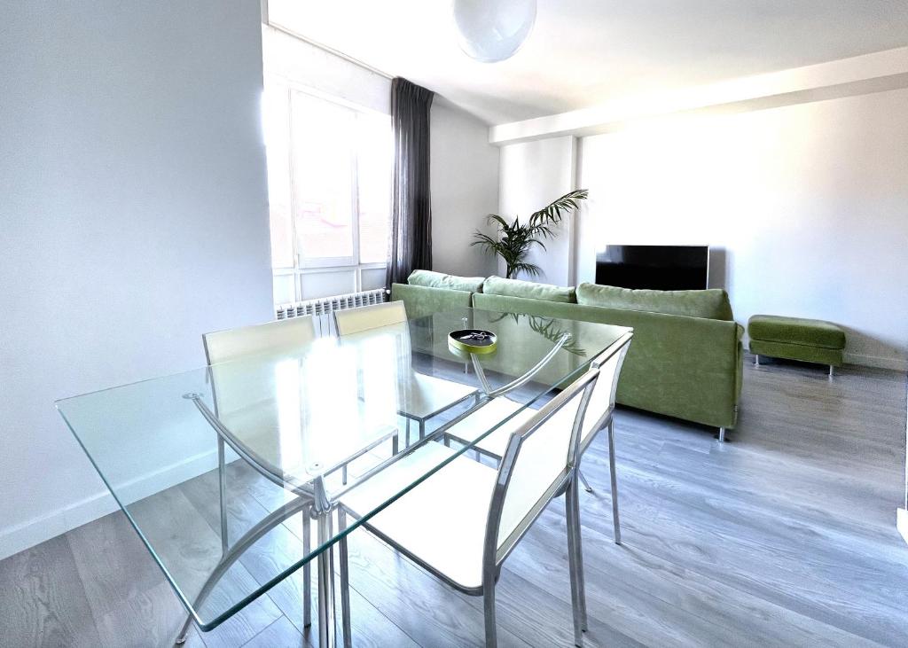 a living room with a glass table and a couch at Luxury Cercas Bajas Vitoria in Vitoria-Gasteiz