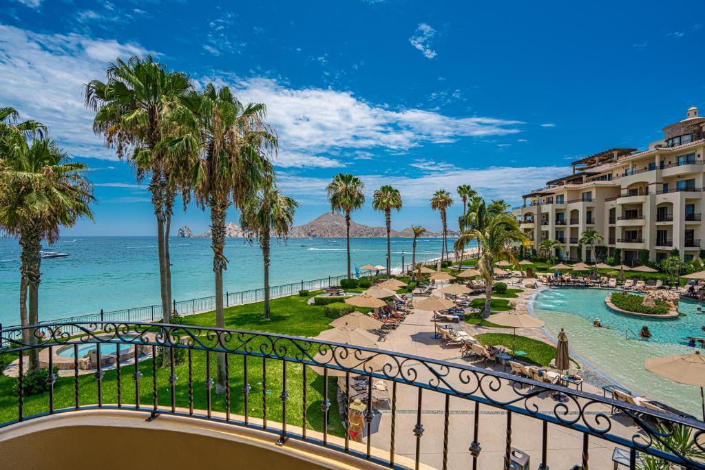 a view of the beach from a balcony of a resort at Villa La Estancia - Medano Beach Villas in Cabo San Lucas